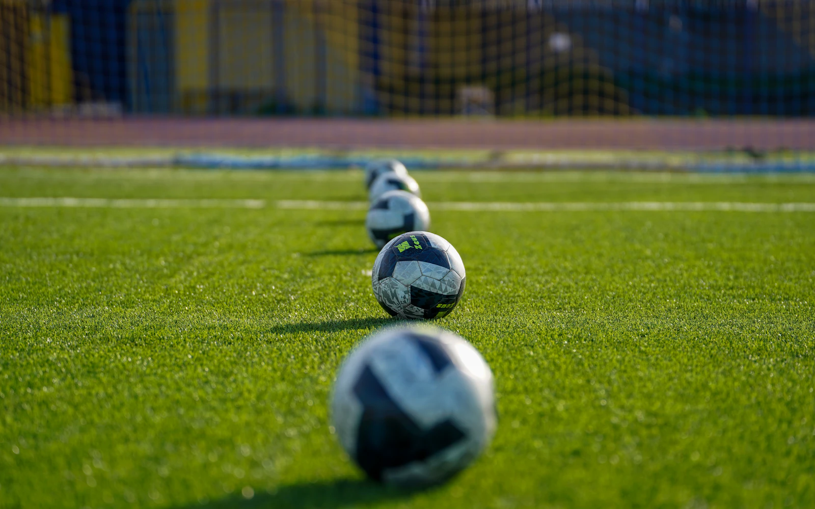 Footballs arranged on a football pitch